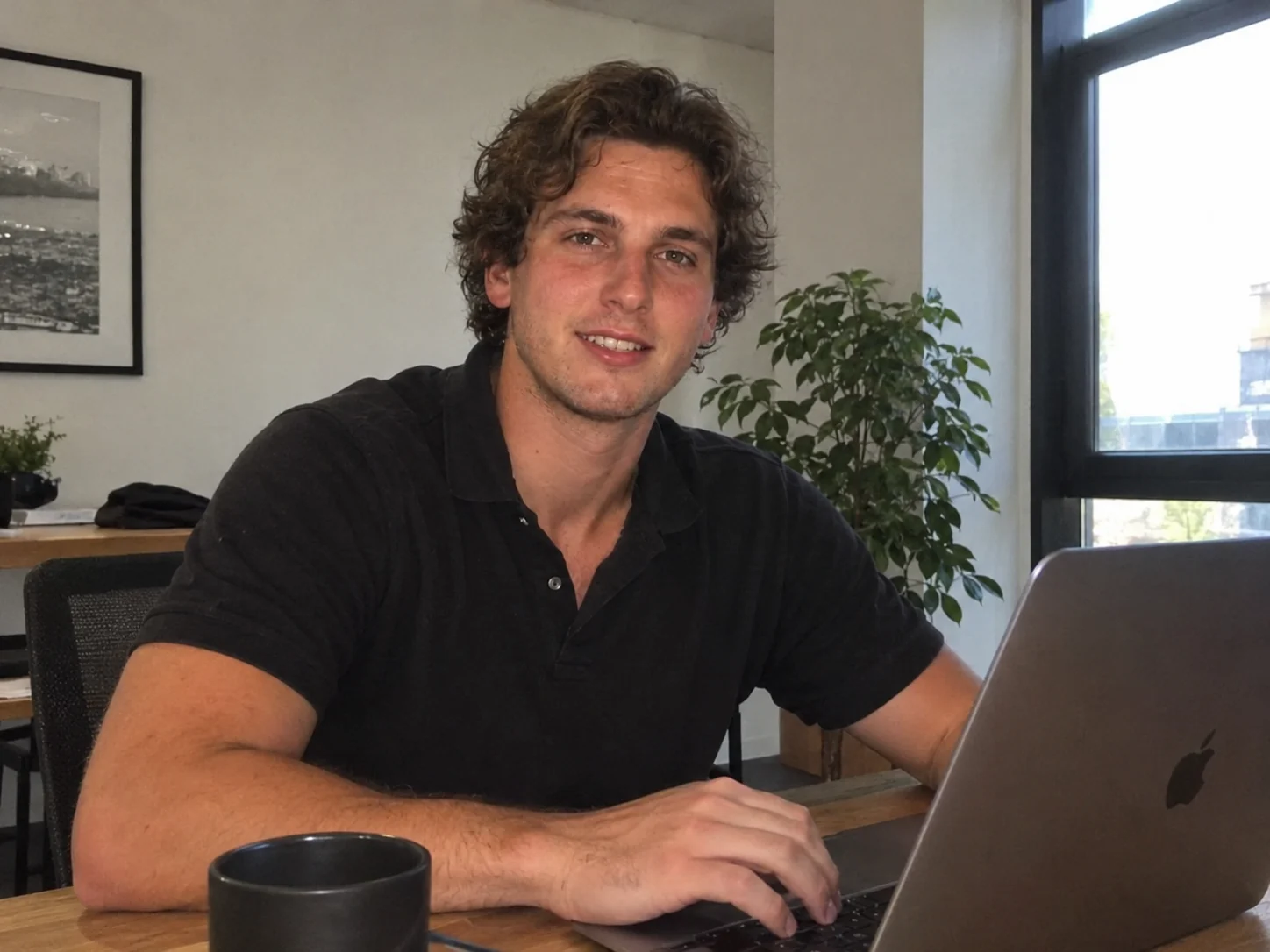 Founder seated at a desk in a bright office